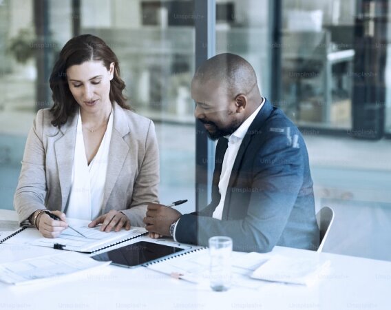 A team collaborating around a laptop