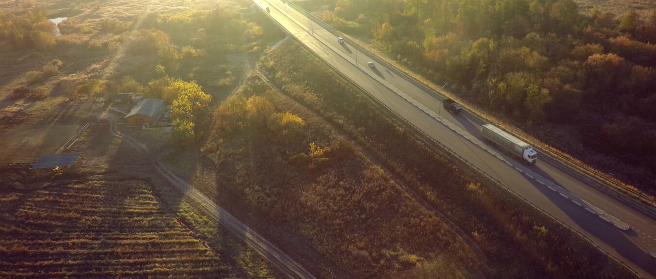 trucks on a road through woodland