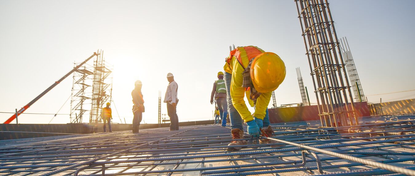 Construction workers fabricating steel reinforcement bar at the construction site
